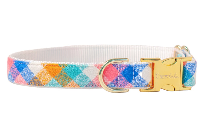 A colorful flannel, pastel dog collar featuring cheerful checks in pink, orange, and blue, with a bright lining and polished hardware.