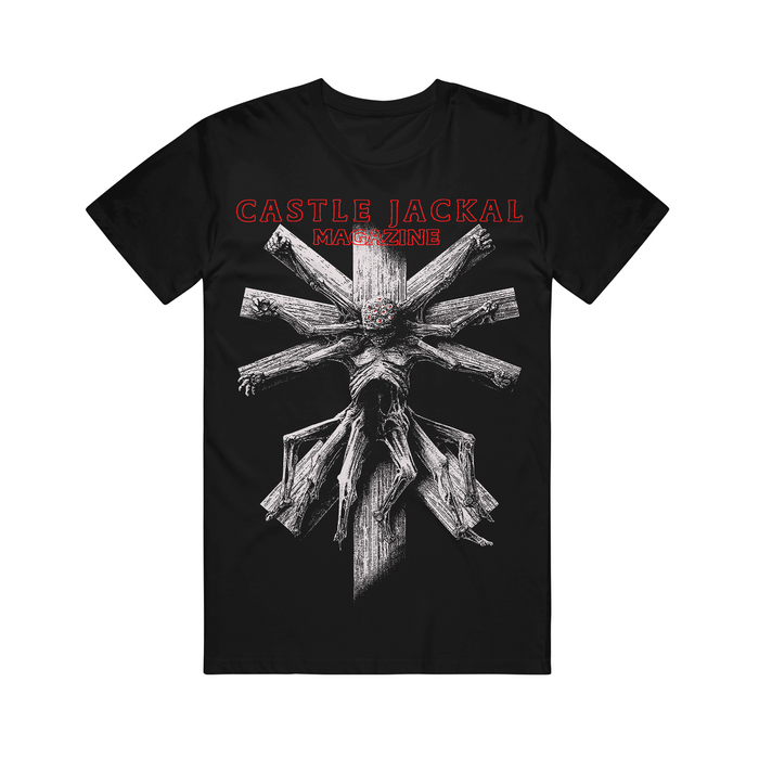 Castle Jackal black Comfort Colors tee with a detailed white wooden cross, skeletal gnarled hands/limbs, and bold red "CASTLE JACKAL MAGAZINE" text above.
