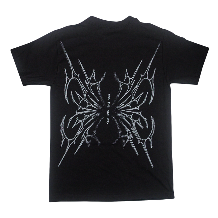 Black t-shirt by Sorry X, crafted from 100% U.S cotton, featuring an abstract, symmetrical white line design on the back that resembles sharp intersecting shapes or wings. Includes small stylized text in the center and offers a relaxed fit inspired by classic American Apparel T-Shirts.