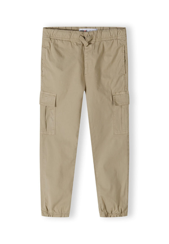 Boys cargo trousers in beige with elastic waistband and side pockets, front view.