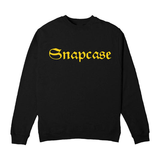 A classic black crewneck sweatshirt by Snapcase, featuring large bold yellow gothic lettering across the chest—a must-have gold logo piece for standout streetwear fans.