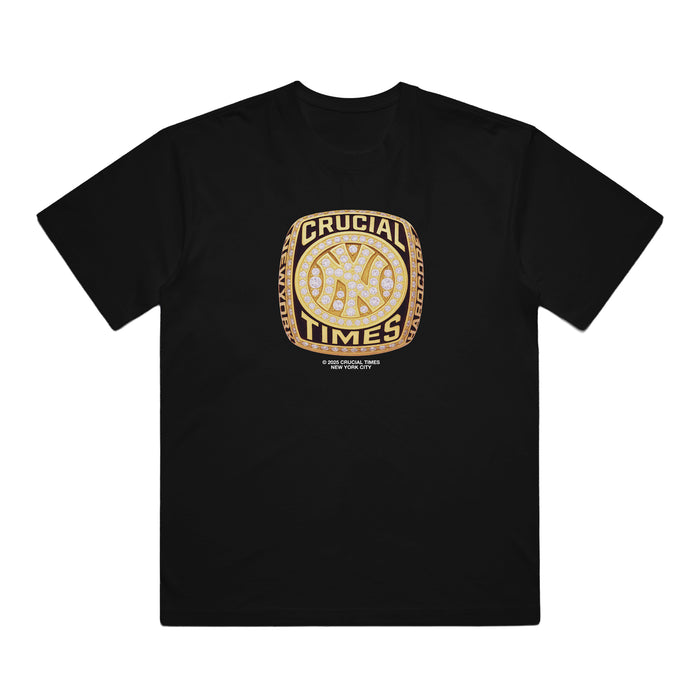 Crucial Times black Comfort Colors t-shirt with a bold gold and diamond championship ring graphic, "CRUCIAL TIMES" text around a baseball icon, and fine print below. Perfect collectible apparel for true champions.