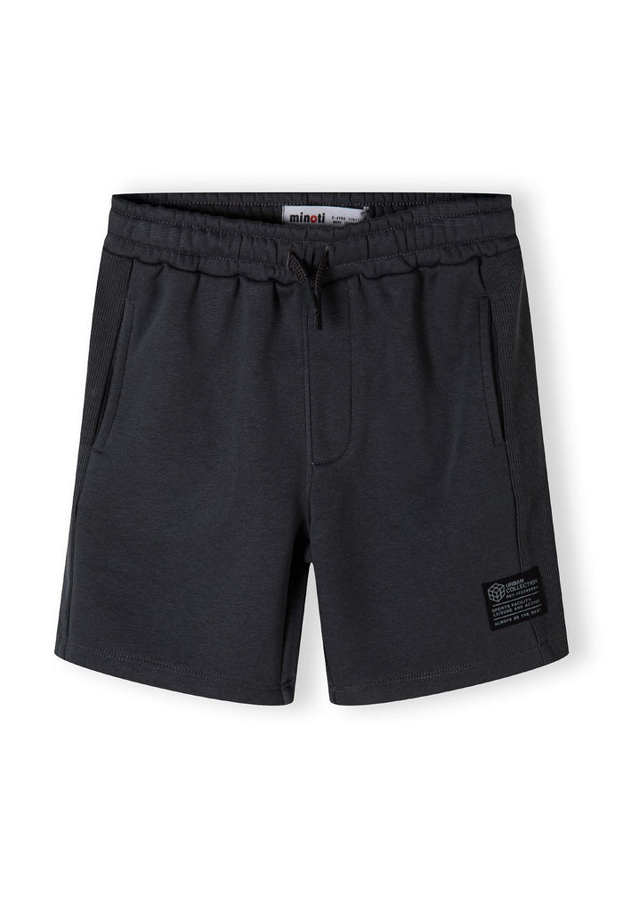 Boys fleece shorts in grey with ribbed side panels, front view, featuring two side pockets and a decorative patch.
