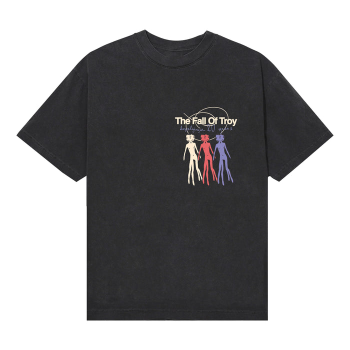 Black American Apparel T-shirt by The Fall of Troy, featuring their name and three outlined humanoid figures in cream, red, and purple below the text, with a faint circular background design—a bold pick for printed tee fans.