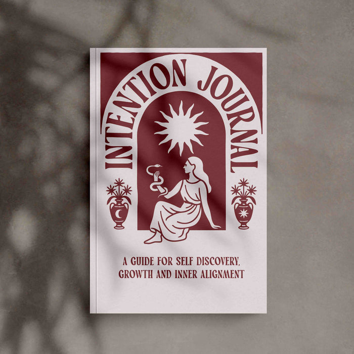 Intention Journal cover with a woman silhouette holding a snake and text on a gray background