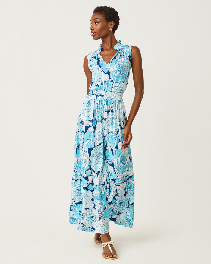 Woman wearing a blue floral dress on a white background