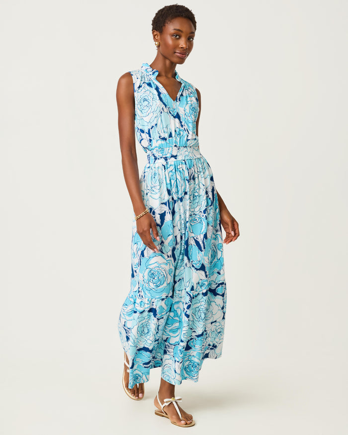 Woman wearing a blue floral dress on a white background