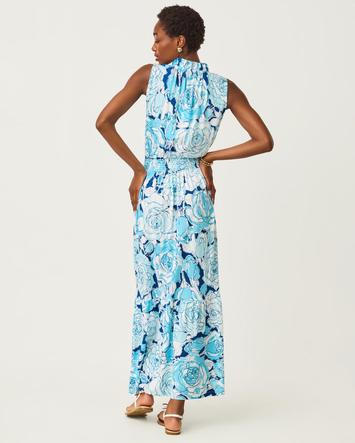 Woman wearing a blue floral dress on a white background