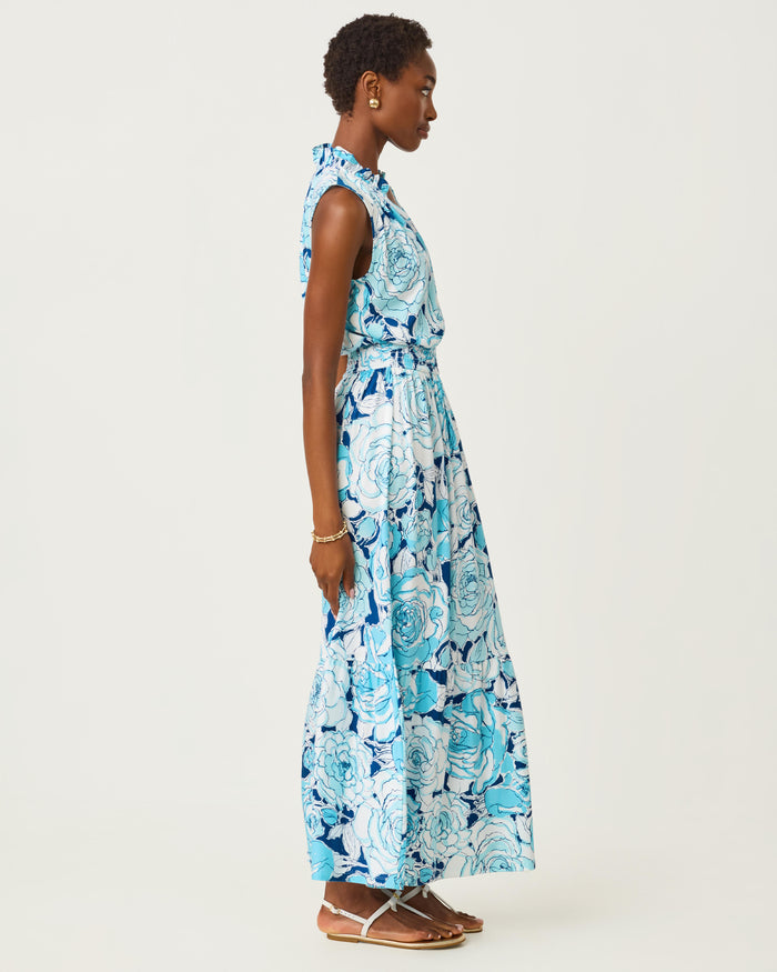 Woman wearing a blue floral dress on a white background