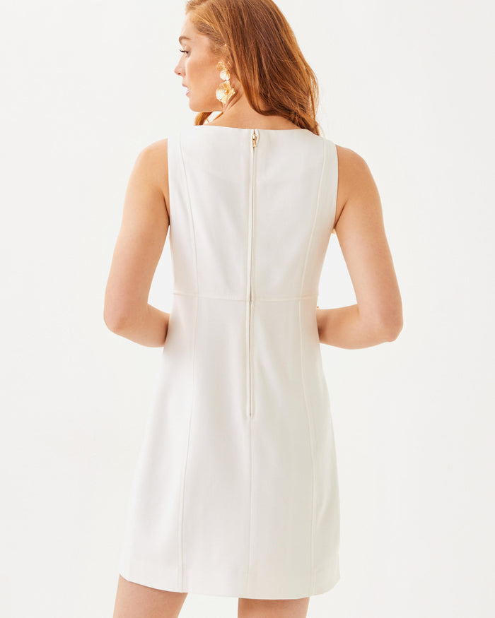 Back view of the Lilly Pulitzer Trini Viscose Shift Dress. A white sleeveless dress with gold detailing around collar and hidden zipper closure