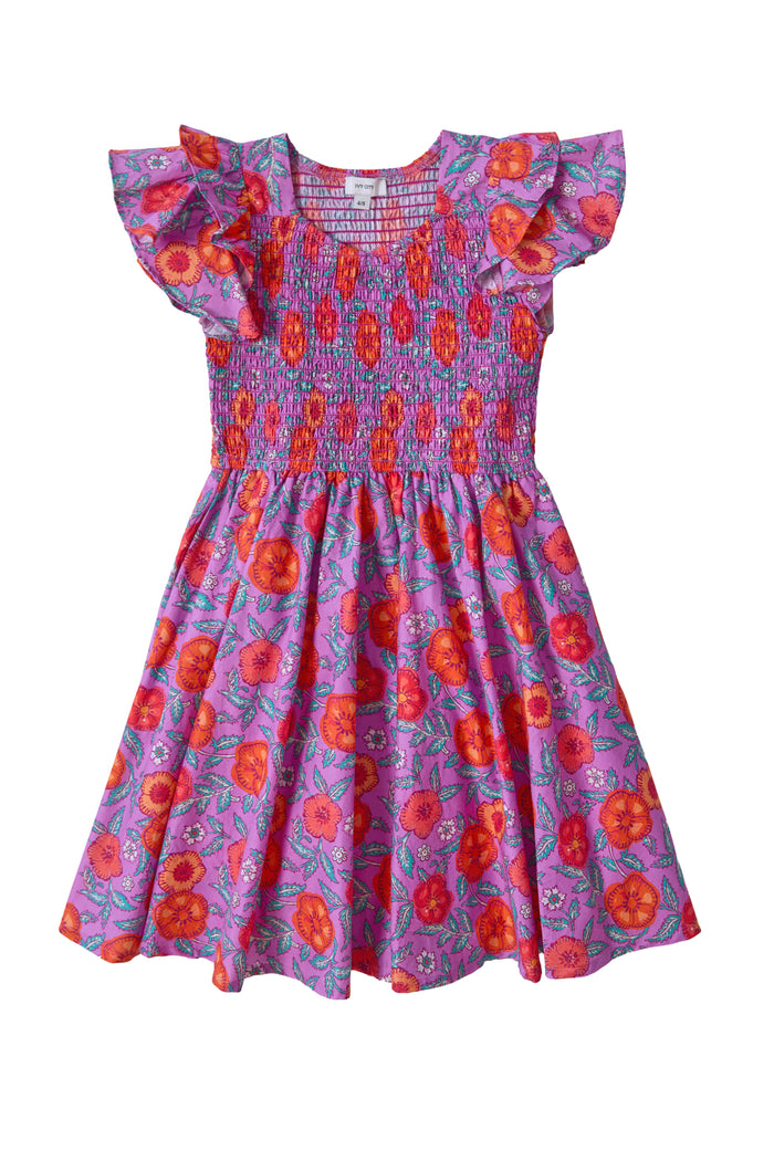 The Ivy City Co Mini Hattie Dress in Thistle Flower Poppy Woodblock is a girls' cotton midi dress featuring ruffled sleeves, a smocked bodice, and a flared, knee-length skirt with a charming red and orange floral pattern.