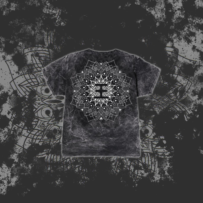A black and gray tie-dye Reflections T-Shirt features a large, intricate white mandala on the back, set against a dark grunge-style background with a subtle oversized mandala pattern.